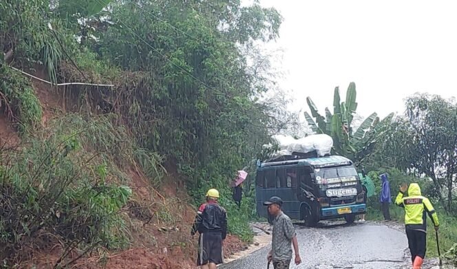 
 Polisi Bersama Warga Bersihkan Jalan dari Material Longsor Saat Patroli